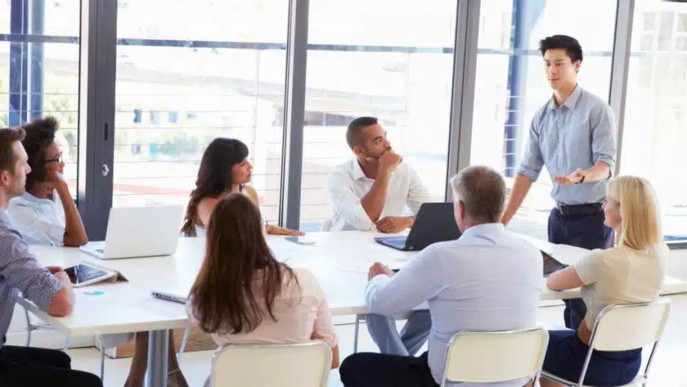 Team assembling in an office setting to emphasize collaboration importance