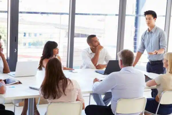 Team assembling in an office setting to emphasize collaboration importance