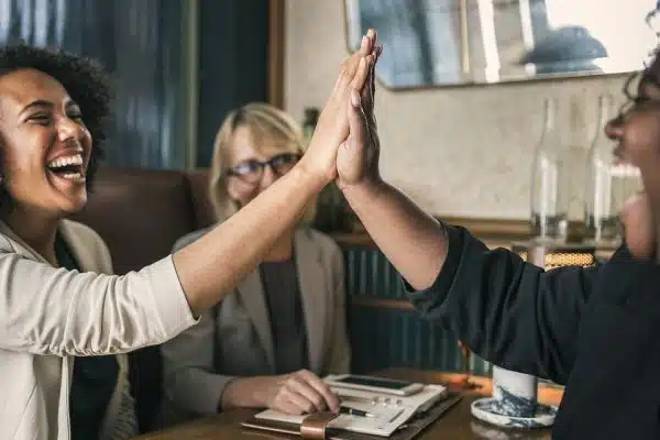 Two people raised their hands together and exchanged a high five.