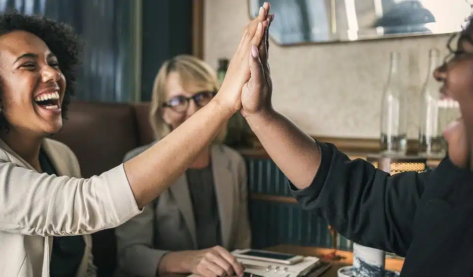 Two people raised their hands together and exchanged a high five.