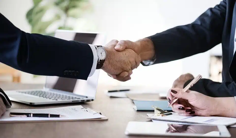 Businessmen shaking hands, symbolizing agreement or partnership.