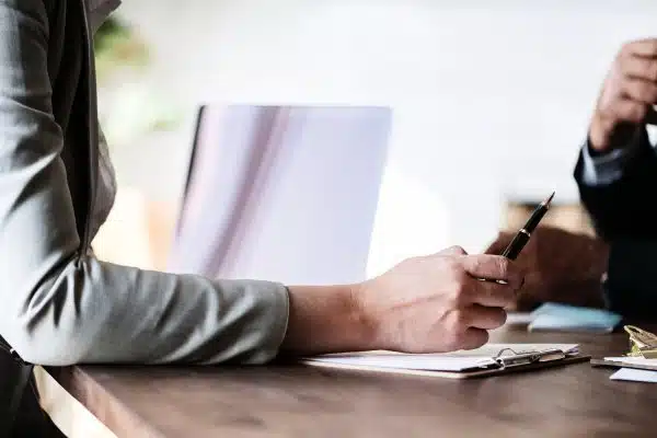 woman holding a pen while discussing