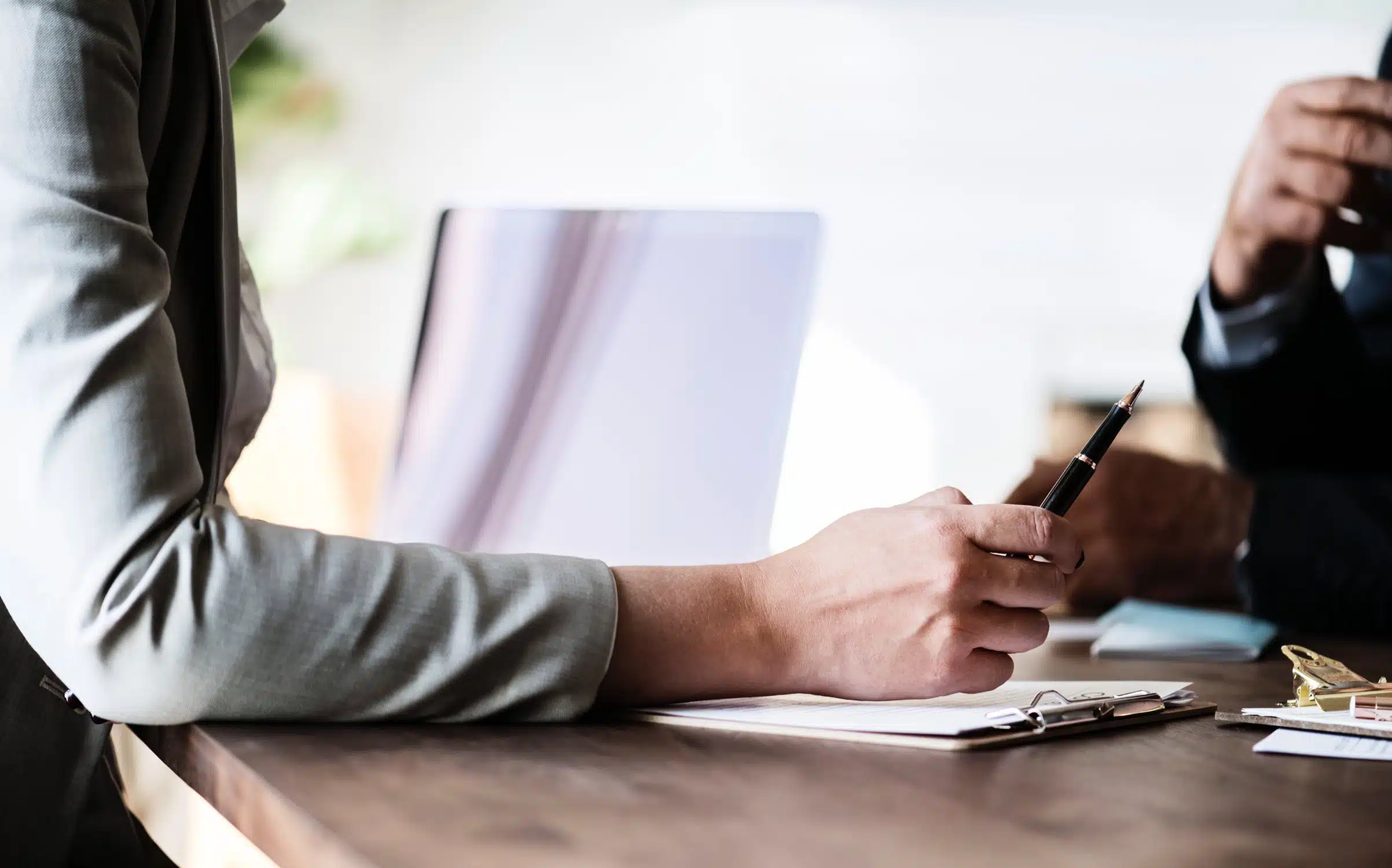 woman holding a pen while discussing