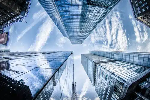 High-rise office buildings against a clear blue sky.